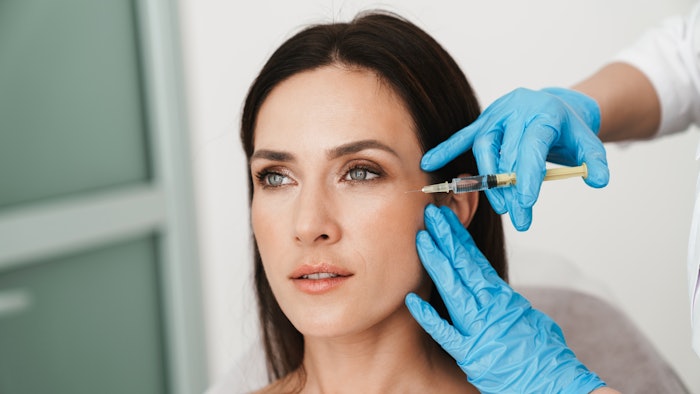 Photo of beautiful woman getting mesotherapy treatment in face