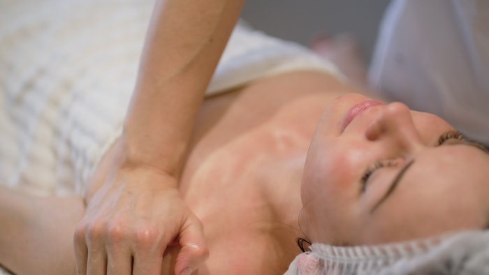 Facial skincare. Hands of masseur. Woman at beauty sp