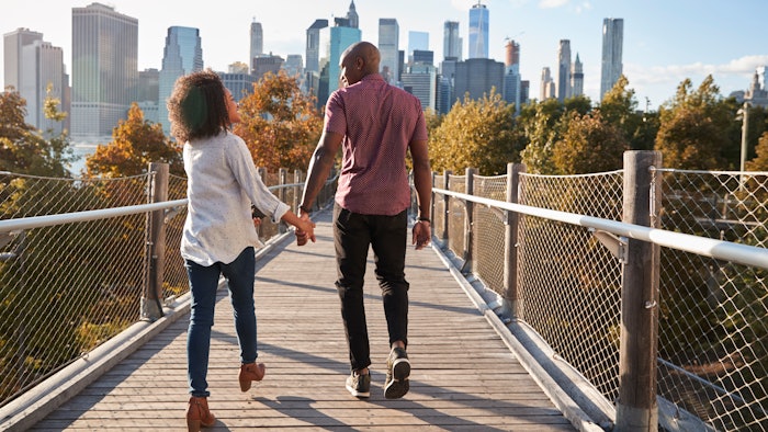 Couple Visiting New York With Manhattan Skyline In Background