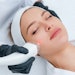 Young woman receiving laser treatment in cosmetology clinic