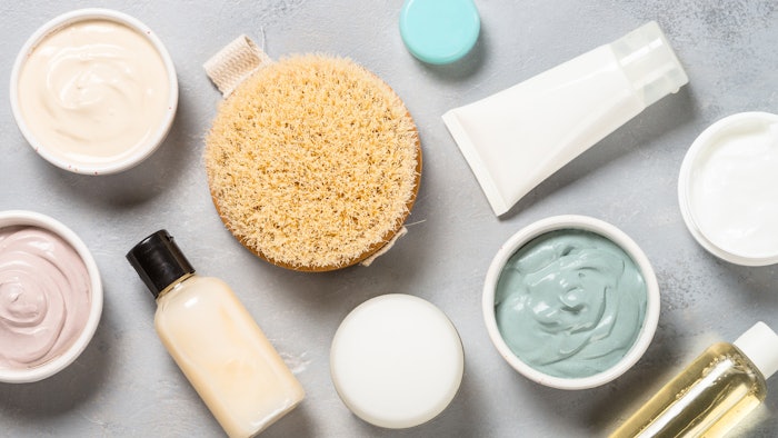 Clay mask on pink bakground, skincare product.