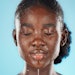 Young woman washing her face