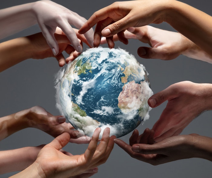 Hands holding, touching planet Earth, close up on grey background. Environment save, taking care of nature and ecology, supporting hands concept. Globe woldwide protection, traveling. Beauty.