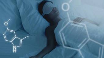 Woman sleeping peacefully in bed as outlines of molecules float above.