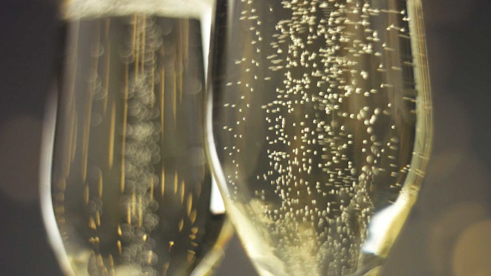 champagne in glasses bubbles up close