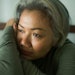 attractive middle aged woman with grey hair sad and depressed in bed feeling scared and lonely thinking worried