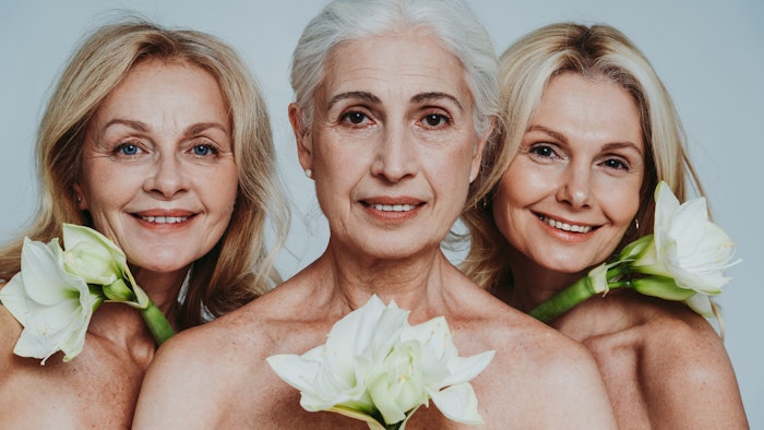 Beautiful senior women posing with flowers to symbolize women's sexual health.