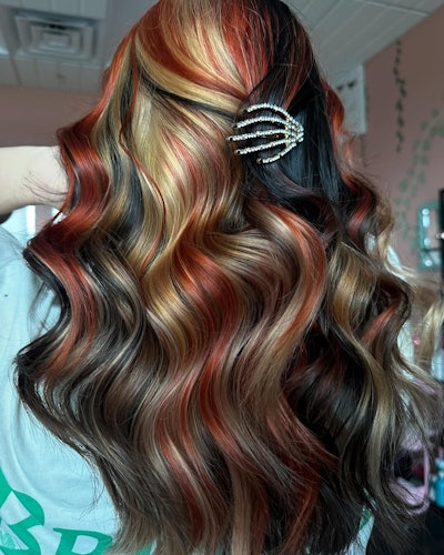 Glossy calico hair trend with blended red, blonde and dark brunette strands