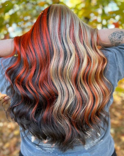 Ribbony calico hair trend with red and blonde stands layered on top of a brunette base