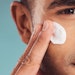 man using facial lotion