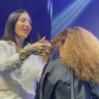 Presley Poe styles her model's hair on-stage at L.I.V.E. 312 at Joe's Live in Rosemont.