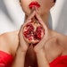 Woman Neck Down Red Dress Cradling Pomegranate