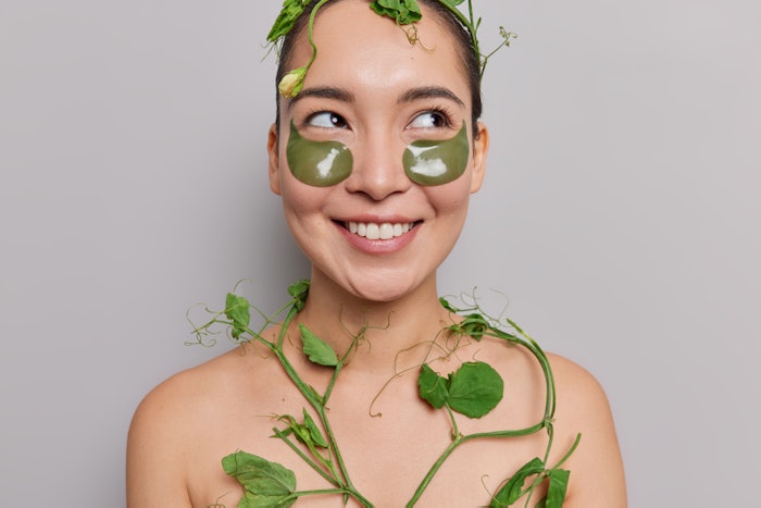 Woman Wearing Green Under Eye Patches Plants And Leaves Adobe Stock 448334173