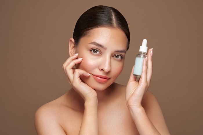 Beautiful Bruunette Holding Serum Beige Background Simple Adobe Stock 818977970