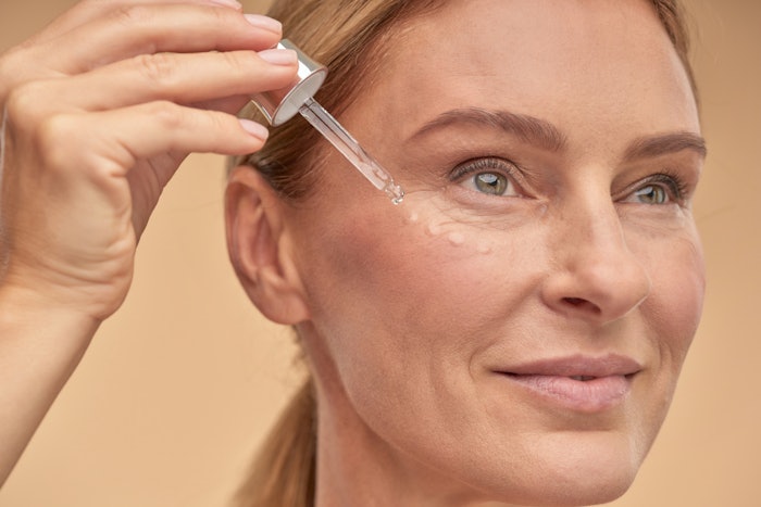 Mature Woman Using Skin Serum Adobe Stock 396008026