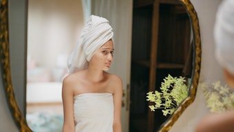 Oily skin might not cause fewer wrinkles—but the treatments for acne just might.