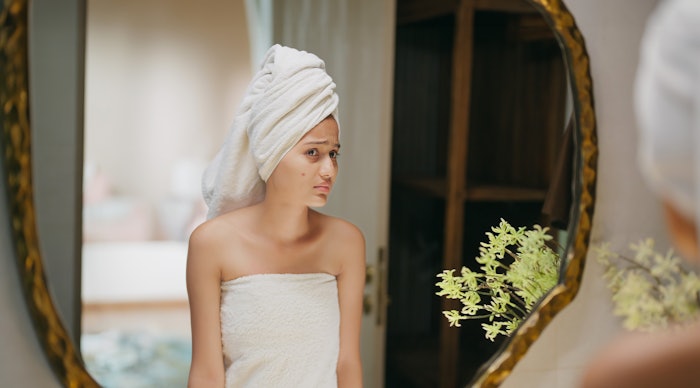 Oily skin might not cause fewer wrinkles—but the treatments for acne just might.