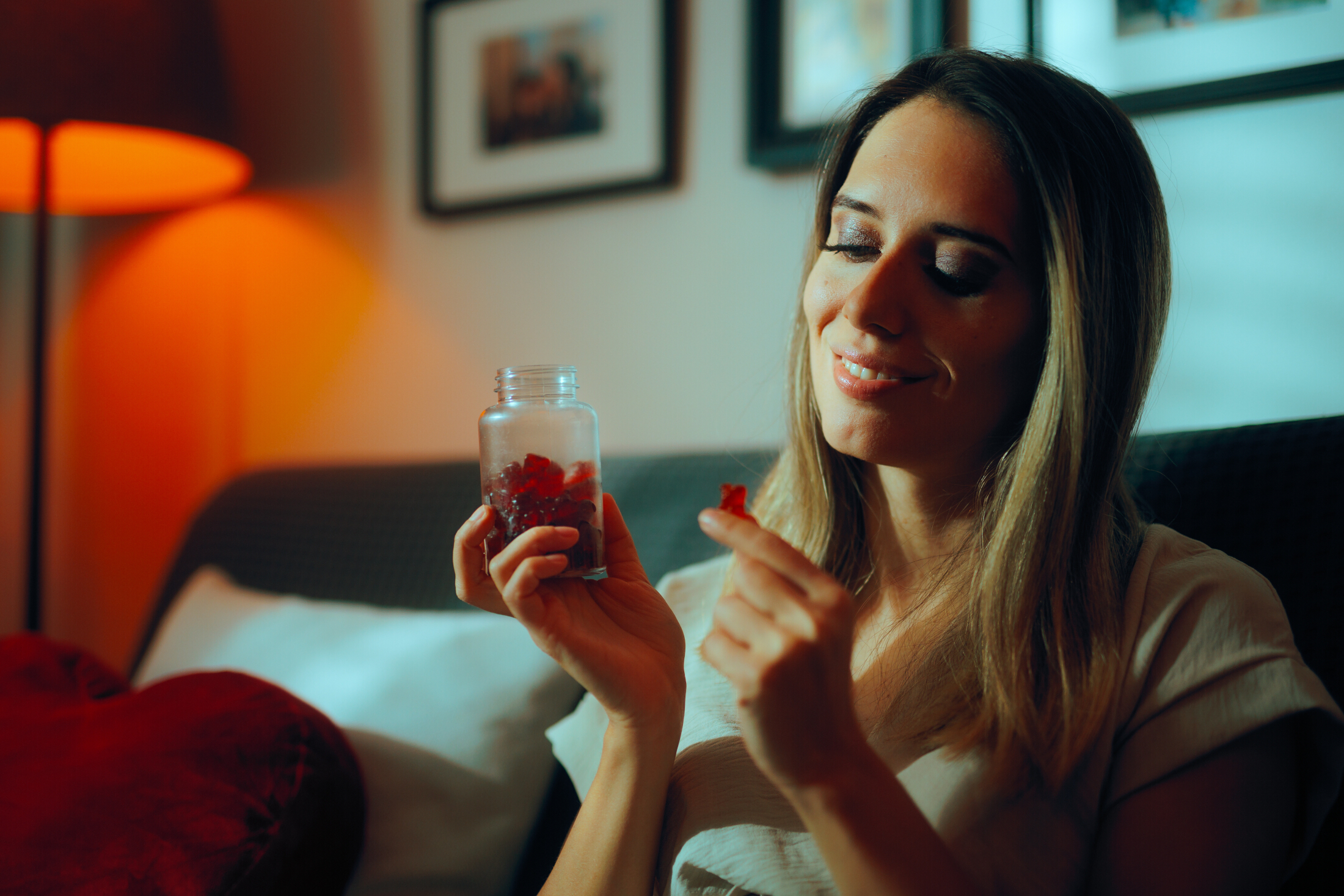 Woman Taking Gummy Suipplement Adobe Stock 1033034872