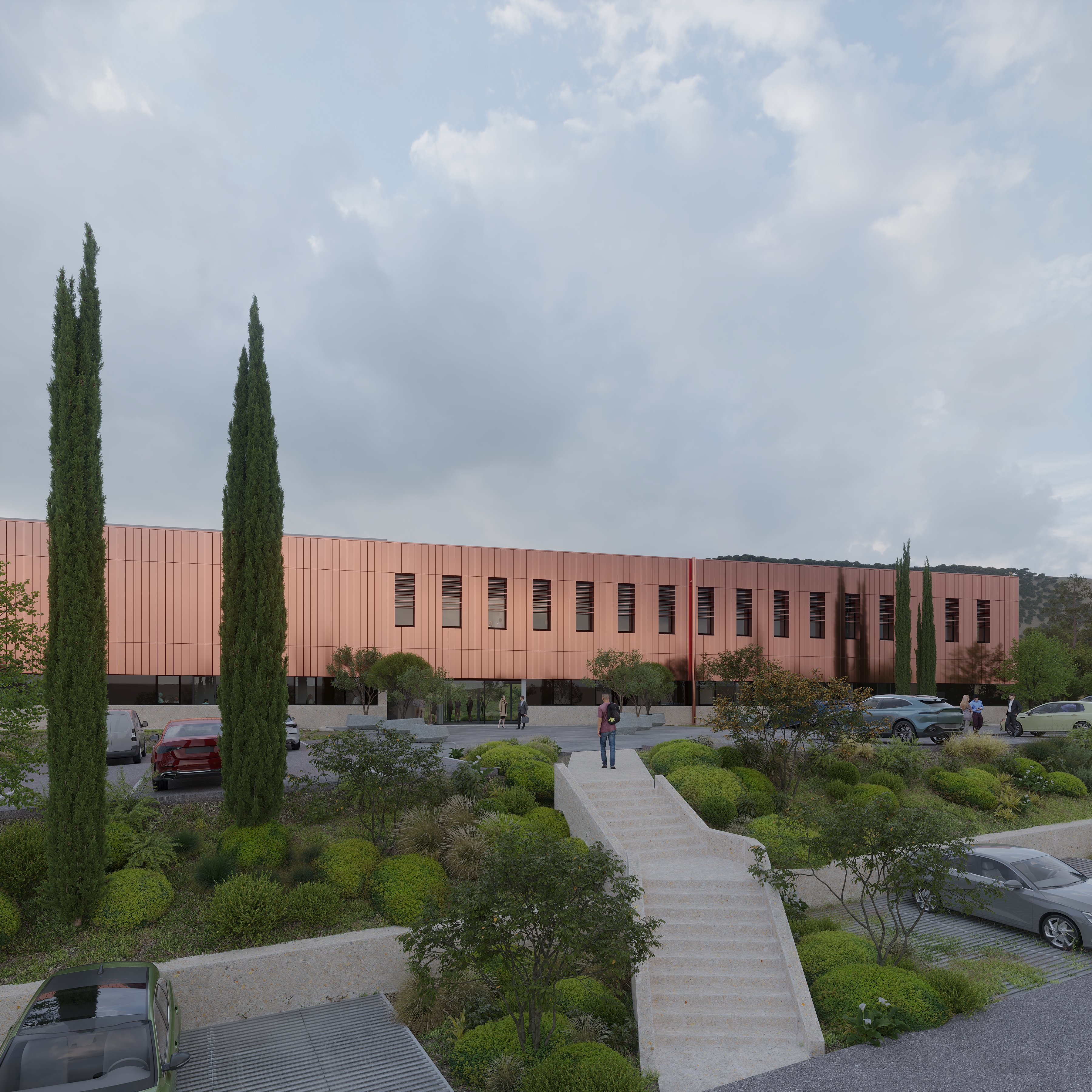 Modern terracotta building with cypress trees, landscaped grounds, and parking area under cloudy sky