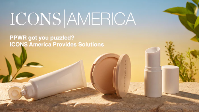 Skincare and cosmetics product collection displayed on sand with green foliage and natural lighting
