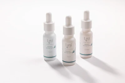 Three Lyra Smart Boosters serum bottles with dropper caps arranged on white background