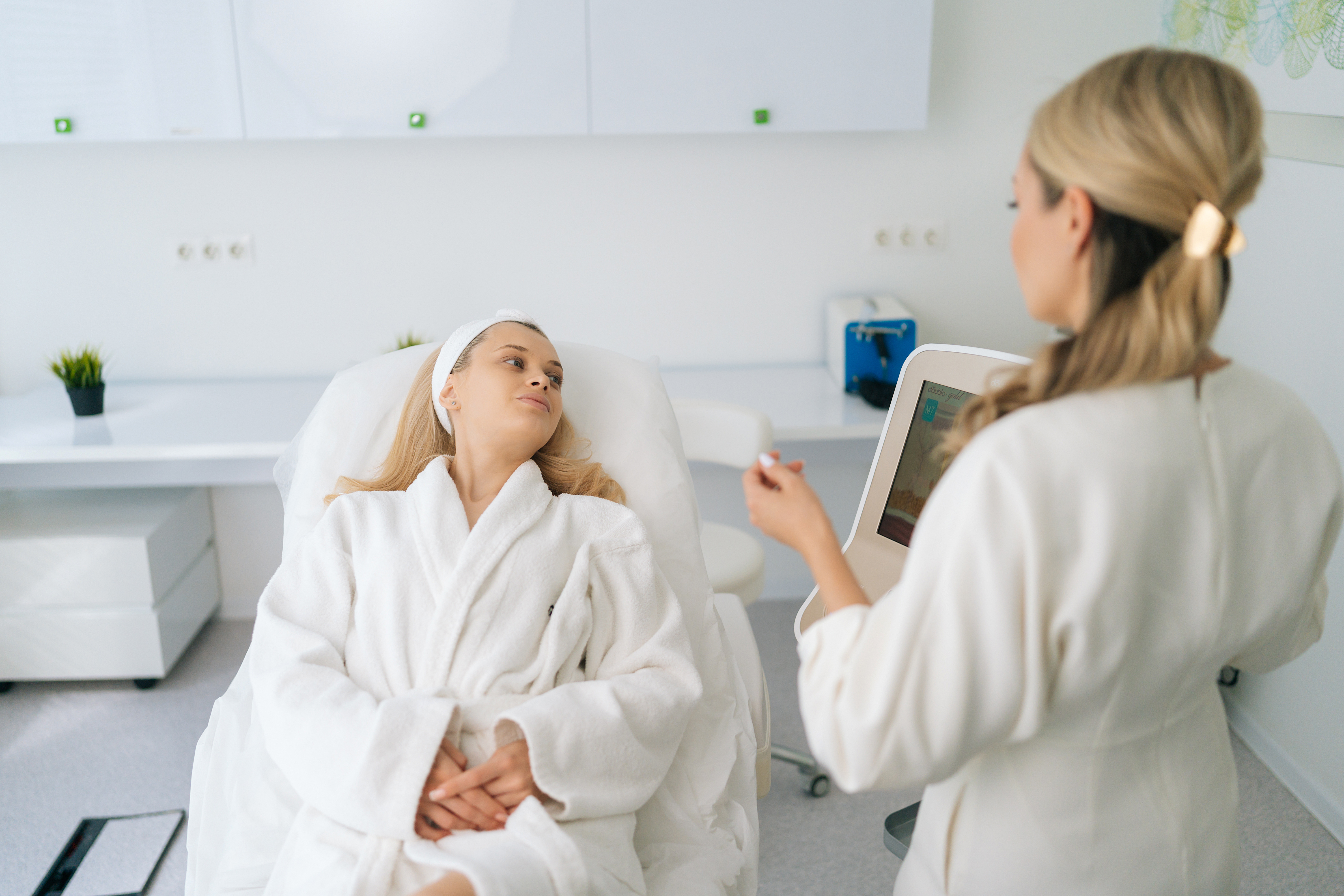 Healthcare professional consulting with patient using digital tablet in modern medical clinic