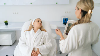 Healthcare professional consulting with patient using digital tablet in modern medical clinic